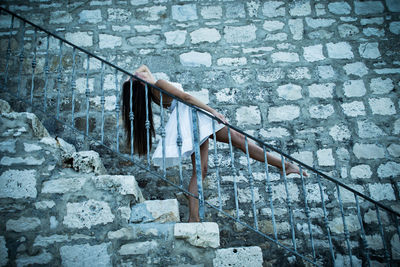 Side view of ballerina practicing on steps