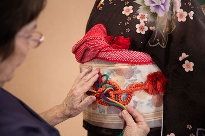 Midsection of woman holding flowers