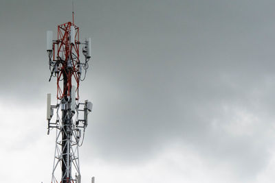 Low angle view of communications tower against sky