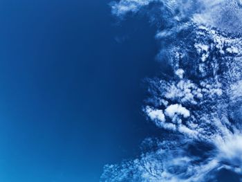 Low angle view of sea against blue sky