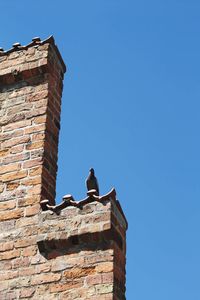 Low angle view of building against clear blue sky