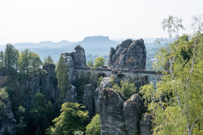 View of trees and rocks against sky