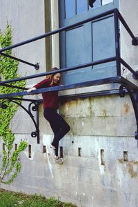 Young woman in front of building