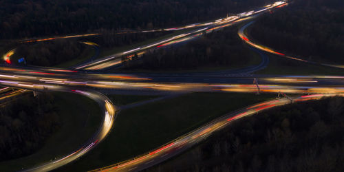 High angle view of light trails on road at night