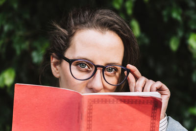 Portrait of young woman holding book