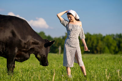 Portrait of woman standing on field