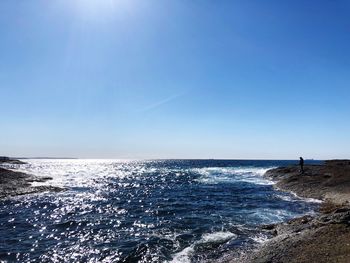 Scenic view of sea against blue sky