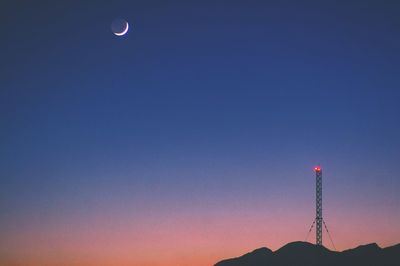 Low angle view of illuminated street light against sky