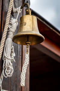 Low angle view of bell hanging on wall