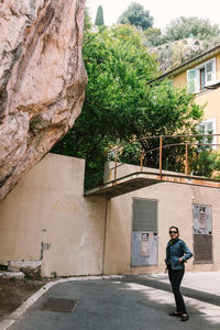 Full length of man standing by building in city