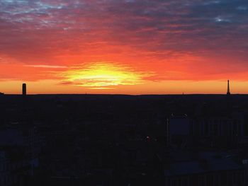 Silhouette cityscape against sky during sunset