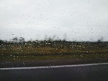 Full frame shot of wet glass window during rainy season