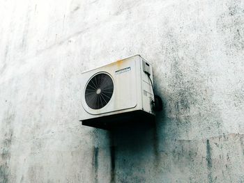 Low angle view of clock on wall