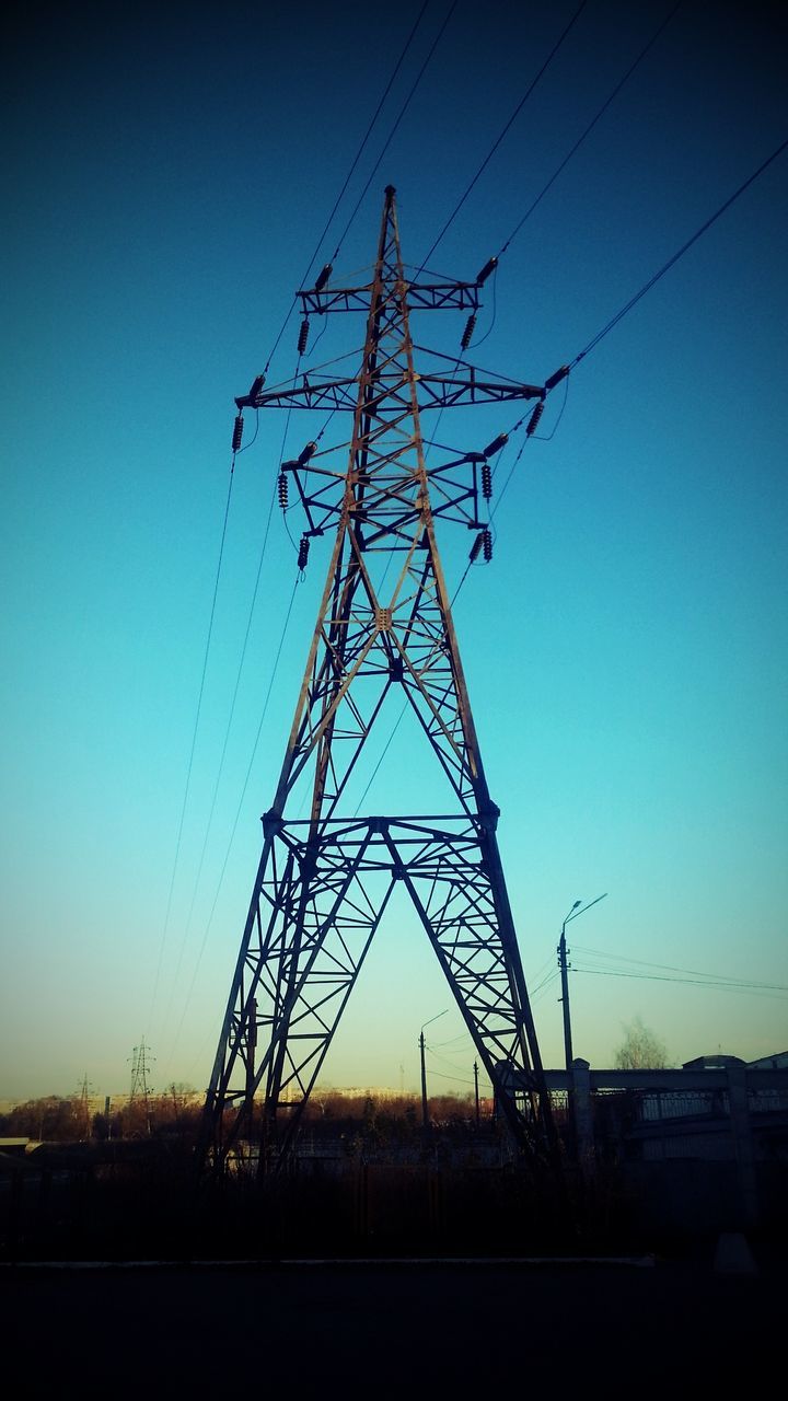 electricity pylon, power line, electricity, power supply, fuel and power generation, connection, silhouette, technology, low angle view, cable, clear sky, sunset, sky, electricity tower, power cable, dusk, blue, outdoors, no people, complexity