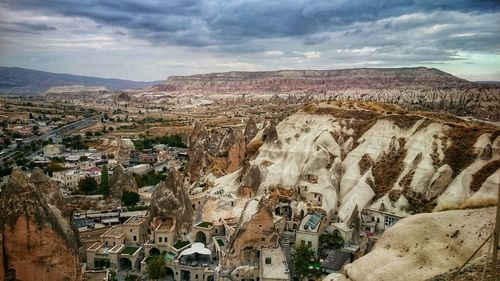 View of cityscape against cloudy sky