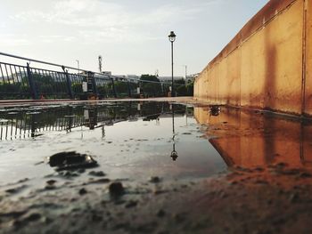 Reflection of buildings in puddle on street