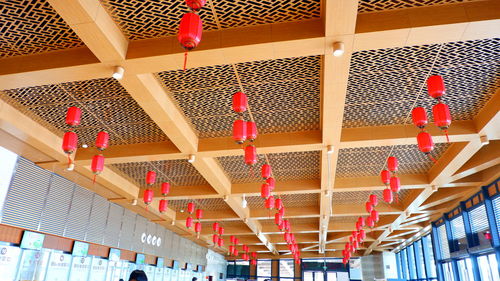 Low angle view of lanterns hanging on ceiling in building