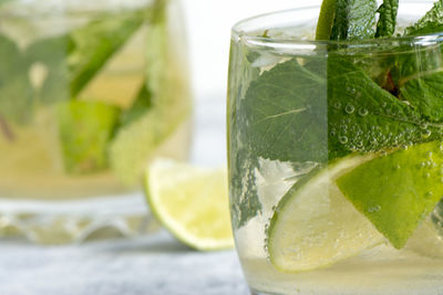 Close-up of mojito on table against white background