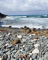 Rocks on beach against sky