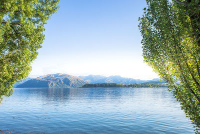 Scenic view of lake against clear blue sky