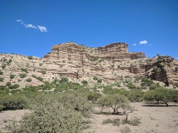 Scenic view of mountain against blue sky