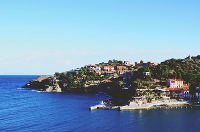 Houses at seaside against blue sky