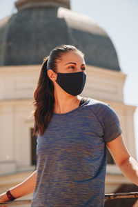 Portrait of young woman wearing sunglasses standing outdoors