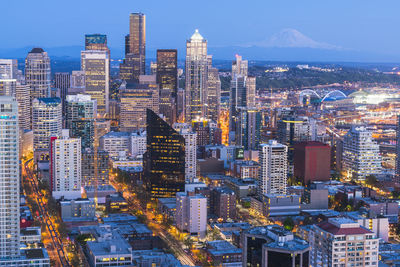 High angle view of illuminated buildings against sky at dusk