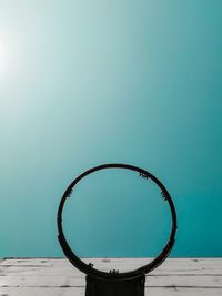 View of basketball hoop against blue sky