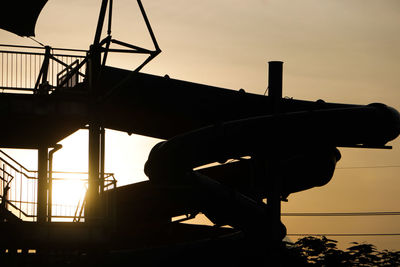 Silhouette built structure at sunset