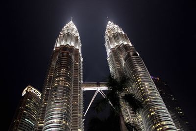 Low angle view of modern building against sky at night