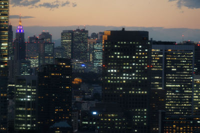 Illuminated buildings against sky at night