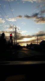 Silhouette car against sky during sunset