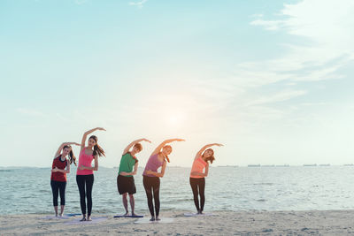 People on beach against sky