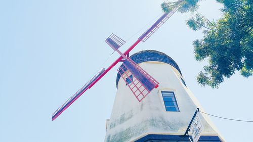 Low angle view of traditional windmill against clear sky