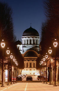 Street amidst illuminated buildings in city at night