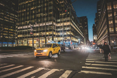 Cars on city street at night