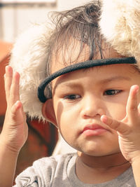 Adorable kid try to wearing earmuffs