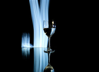 Close-up of wine glass against black background
