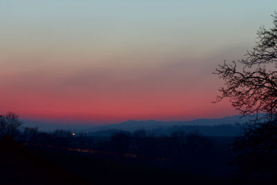 Scenic view of silhouette landscape against romantic sky at sunset