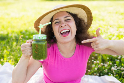 Portrait of a smiling young woman wearing hat