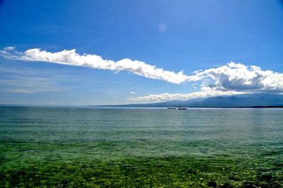 Scenic view of sea against blue sky