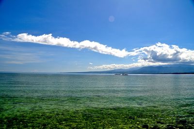 Scenic view of sea against blue sky