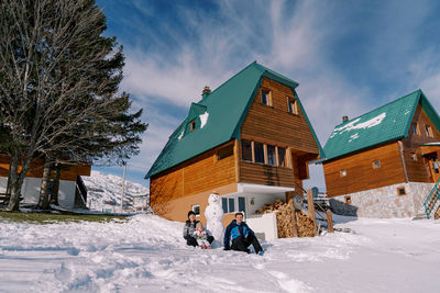 Snow covered houses against sky