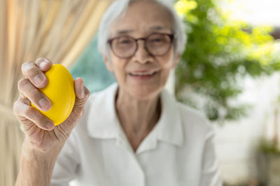 Smiling senior woman holding rubber ball