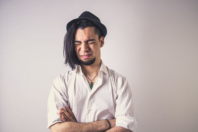 Portrait of young man against white background