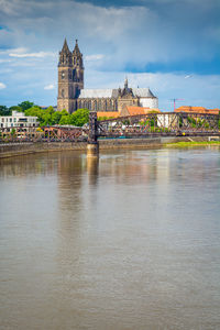 River amidst buildings against sky