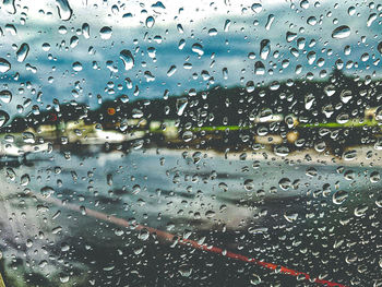 Full frame shot of wet glass window in rainy season