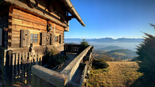 Panoramic view of buildings and mountains against clear blue sky