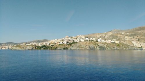 Scenic view of sea and mountains against sky